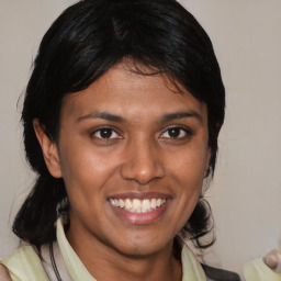 Joyful latino young-adult female with medium  brown hair and brown eyes