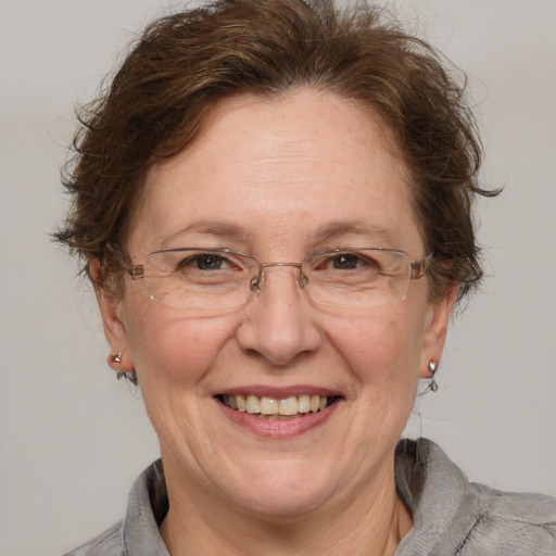 Joyful white middle-aged female with medium  brown hair and brown eyes