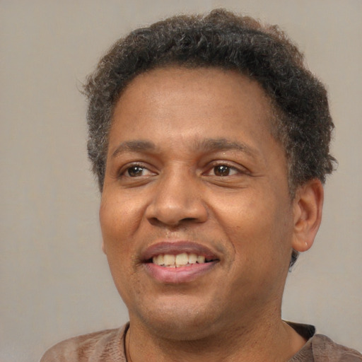 Joyful latino adult male with short  brown hair and brown eyes