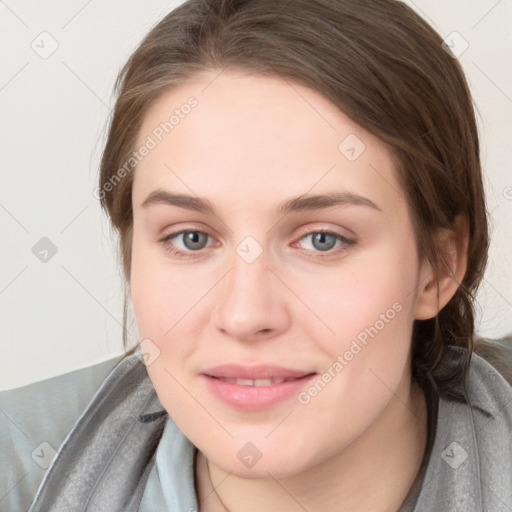 Joyful white young-adult female with long  brown hair and blue eyes