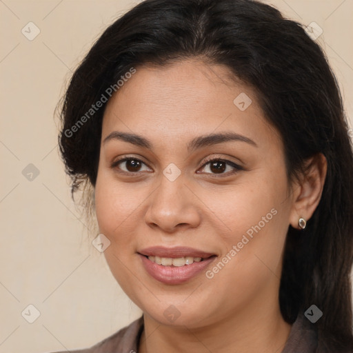 Joyful latino young-adult female with long  brown hair and brown eyes