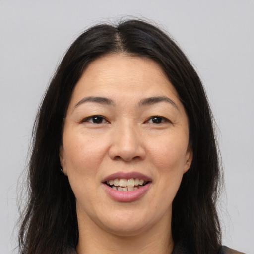 Joyful asian young-adult female with long  brown hair and brown eyes