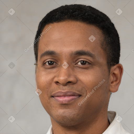 Joyful black young-adult male with short  black hair and brown eyes