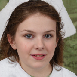 Joyful white child female with medium  brown hair and brown eyes