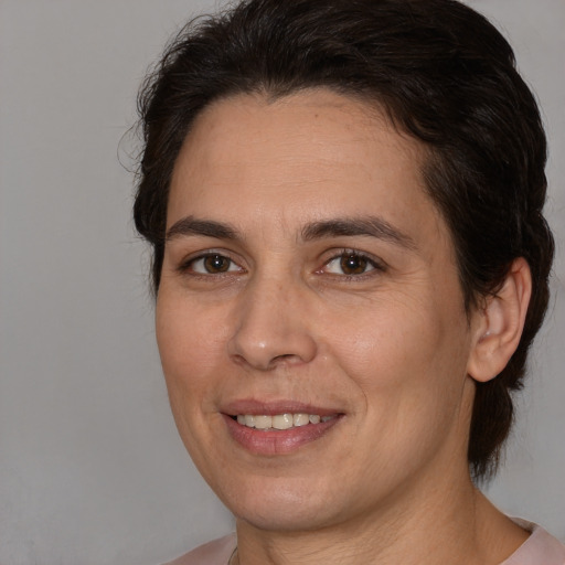 Joyful white adult female with medium  brown hair and brown eyes