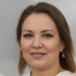 Joyful white adult female with medium  brown hair and brown eyes