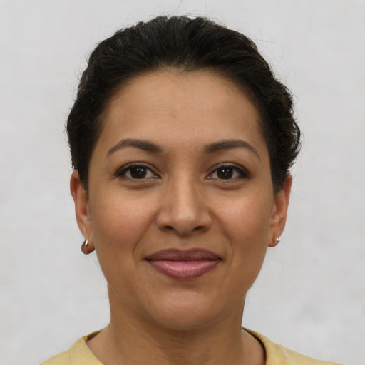 Joyful latino young-adult female with short  brown hair and brown eyes