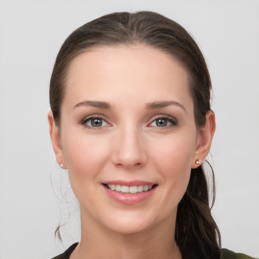 Joyful white young-adult female with long  brown hair and grey eyes