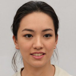 Joyful asian young-adult female with medium  brown hair and brown eyes