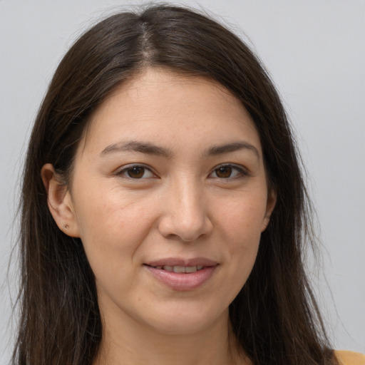 Joyful white young-adult female with long  brown hair and brown eyes