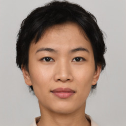 Joyful asian young-adult female with short  brown hair and brown eyes