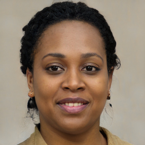 Joyful black young-adult female with long  brown hair and brown eyes
