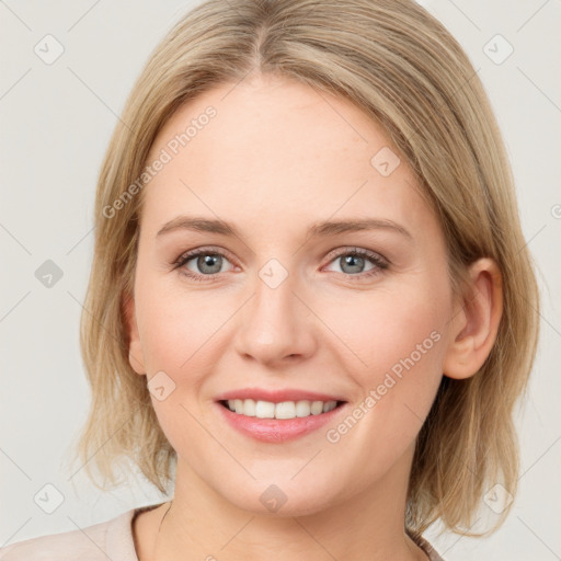 Joyful white young-adult female with medium  brown hair and blue eyes