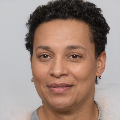 Joyful latino adult female with short  brown hair and brown eyes