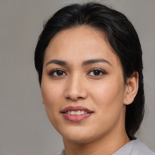 Joyful asian young-adult female with medium  brown hair and brown eyes