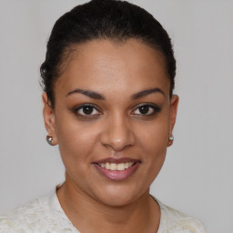 Joyful latino young-adult female with short  brown hair and brown eyes