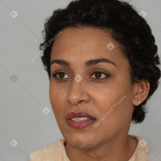 Joyful black young-adult female with short  brown hair and brown eyes