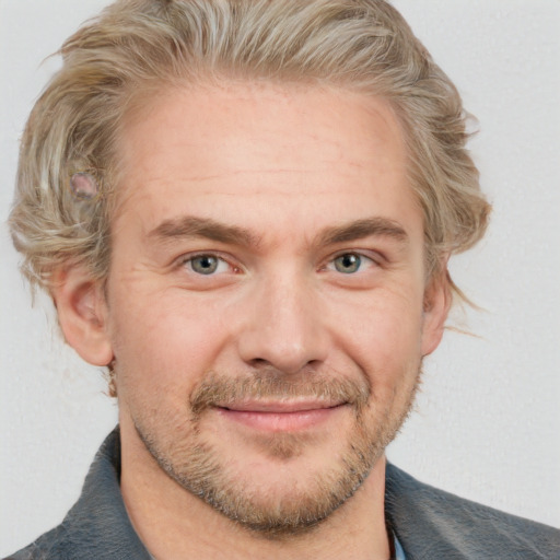 Joyful white adult male with short  brown hair and grey eyes