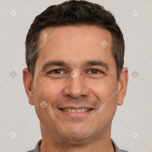 Joyful white adult male with short  brown hair and brown eyes