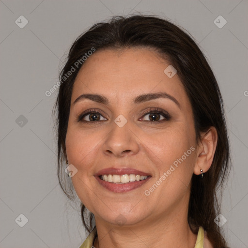 Joyful white adult female with medium  brown hair and brown eyes