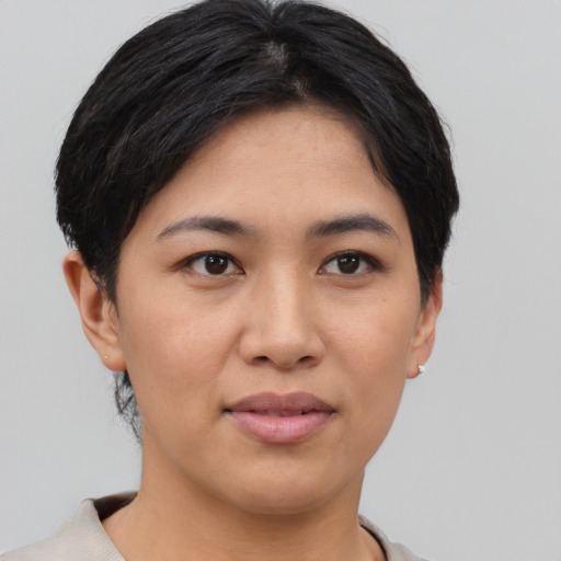 Joyful asian young-adult female with short  black hair and brown eyes