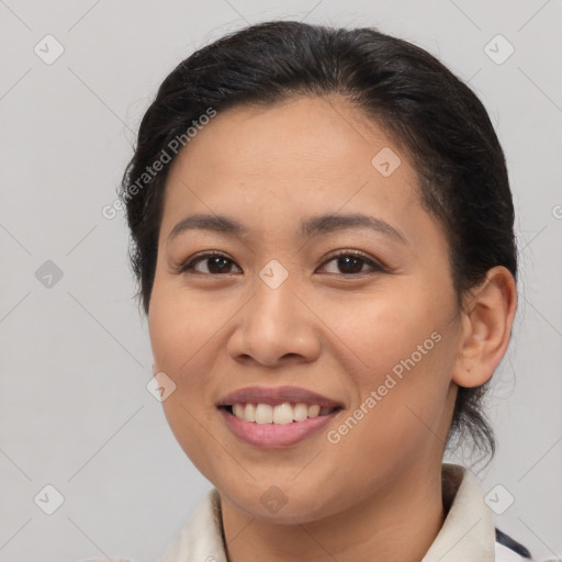 Joyful latino young-adult female with medium  brown hair and brown eyes