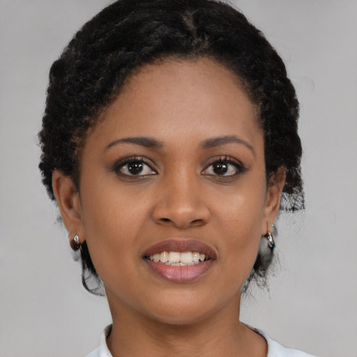 Joyful black young-adult female with short  brown hair and brown eyes
