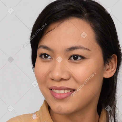 Joyful asian young-adult female with long  brown hair and brown eyes