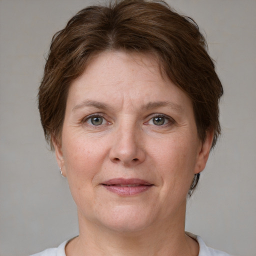 Joyful white adult female with short  brown hair and grey eyes