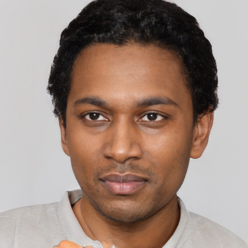 Neutral black young-adult male with short  black hair and brown eyes