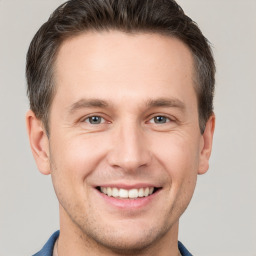 Joyful white young-adult male with short  brown hair and brown eyes