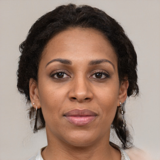 Joyful latino adult female with short  brown hair and brown eyes