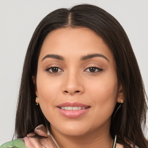 Joyful latino young-adult female with long  brown hair and brown eyes