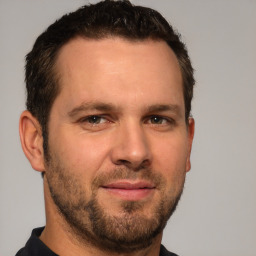 Joyful white adult male with short  brown hair and brown eyes