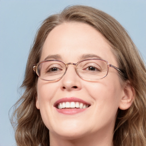 Joyful white adult female with long  brown hair and blue eyes