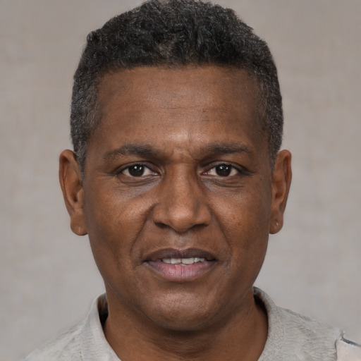 Joyful black adult male with short  brown hair and brown eyes