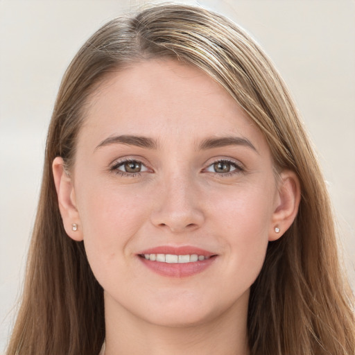 Joyful white young-adult female with long  brown hair and grey eyes