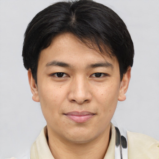 Joyful asian young-adult male with short  brown hair and brown eyes