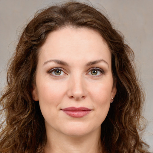 Joyful white young-adult female with long  brown hair and green eyes