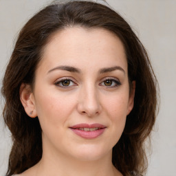 Joyful white young-adult female with medium  brown hair and green eyes