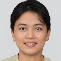 Joyful asian young-adult female with short  brown hair and brown eyes