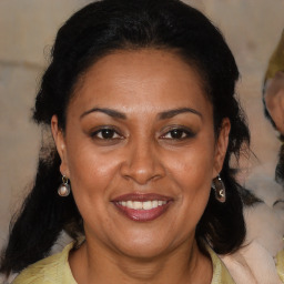 Joyful latino adult female with medium  brown hair and brown eyes