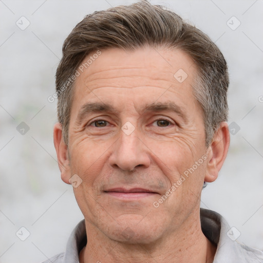 Joyful white middle-aged male with short  brown hair and brown eyes