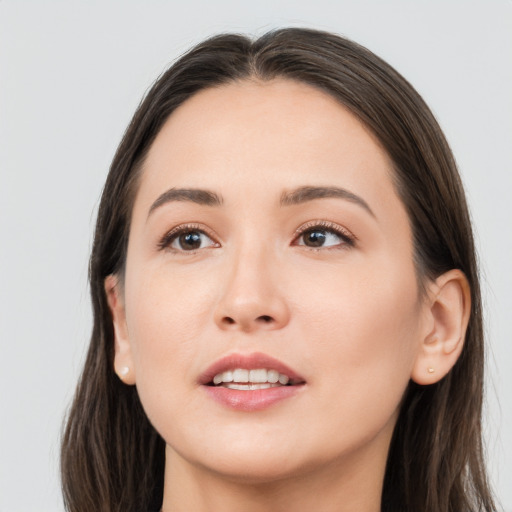 Joyful white young-adult female with long  brown hair and brown eyes