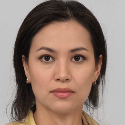 Neutral latino young-adult female with medium  brown hair and brown eyes