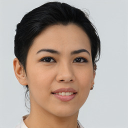 Joyful asian young-adult female with medium  brown hair and brown eyes