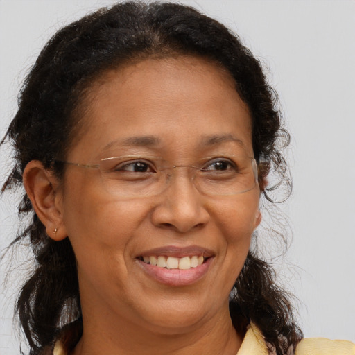 Joyful black adult female with medium  brown hair and brown eyes