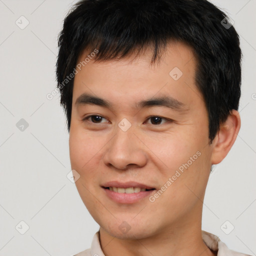 Joyful asian young-adult male with short  brown hair and brown eyes