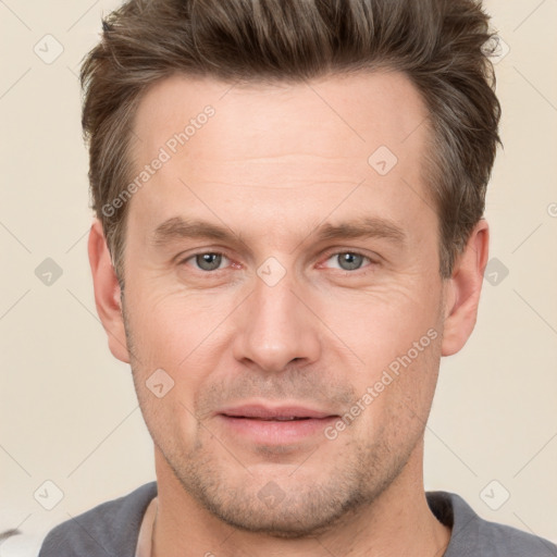 Joyful white adult male with short  brown hair and grey eyes