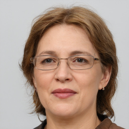 Joyful white adult female with medium  brown hair and grey eyes